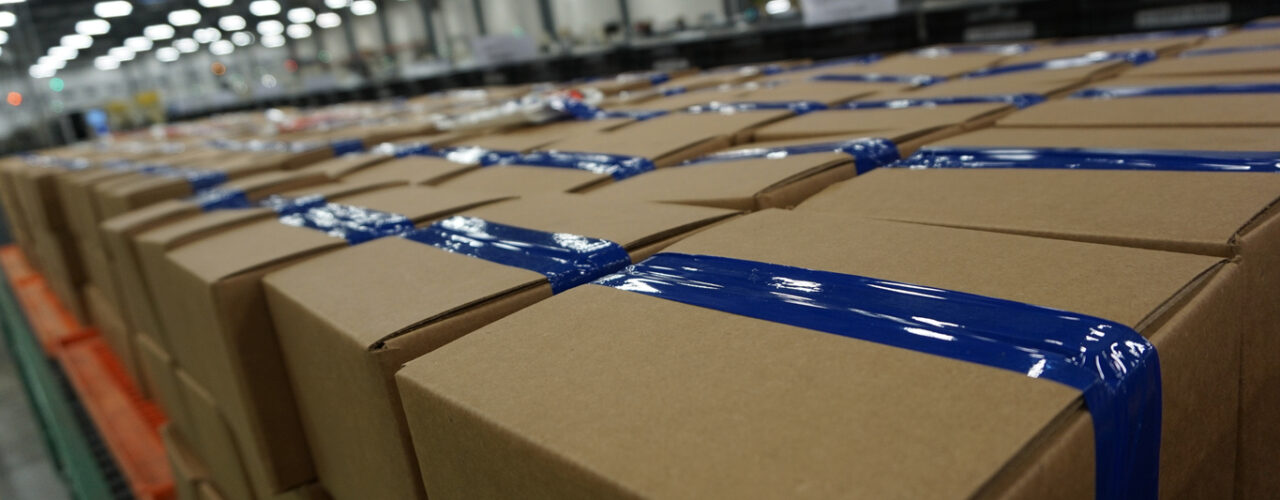 a diminishing perspective picture of boxes ready to ship in the factory