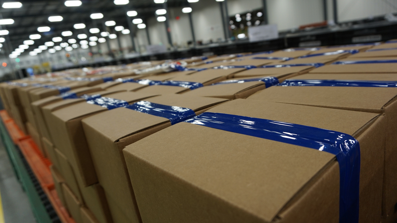 a diminishing perspective picture of boxes ready to ship in the factory