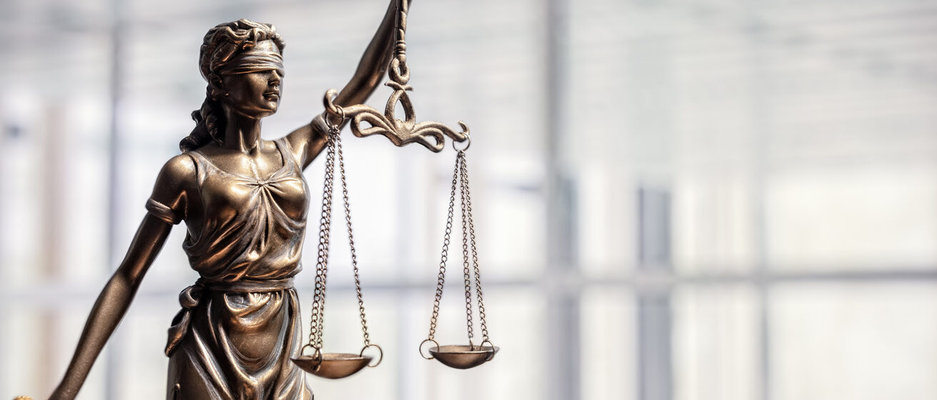 Legal and law concept statue of Lady Justice with scales of justice and office background