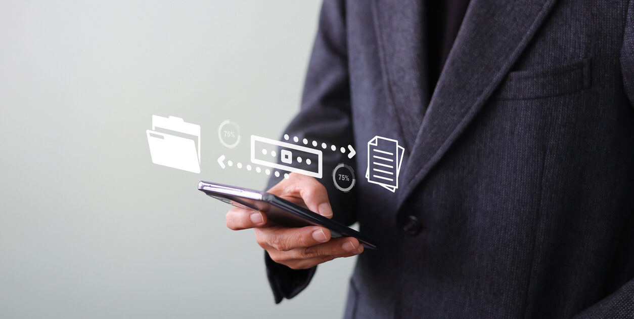 Businessman sending file transfer, backup, and download documents online by smartphone. Online documentation database and process automation Receive - send, and exchange on cloud computing.