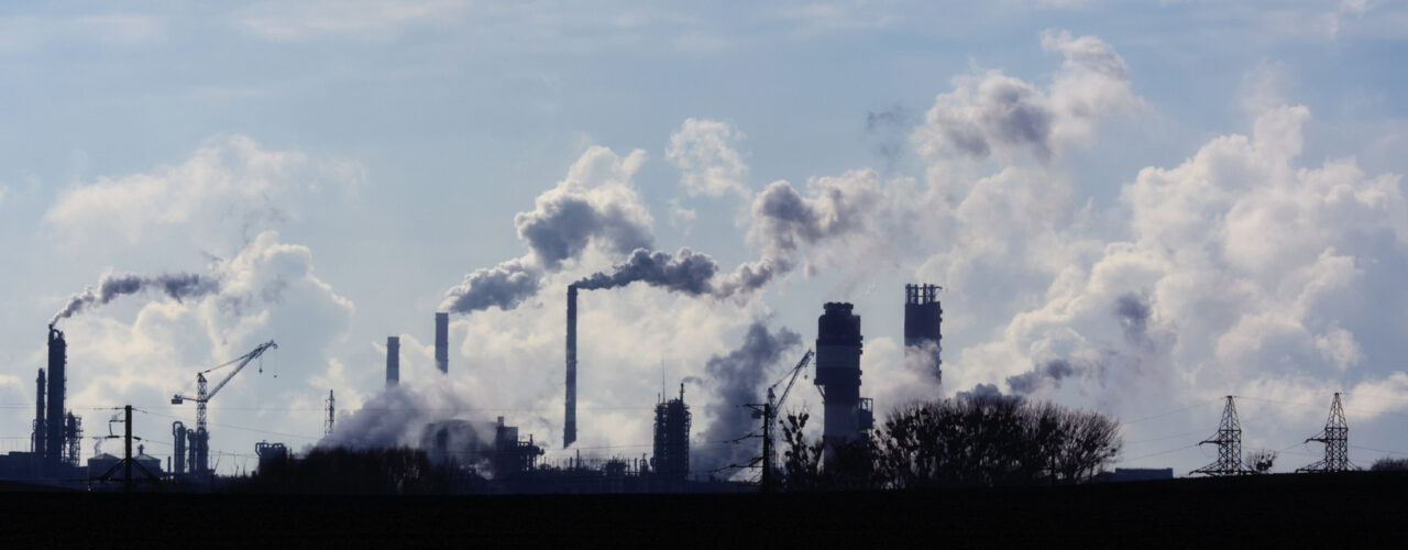 Air pollution from smoke coming out of factory chimneys.