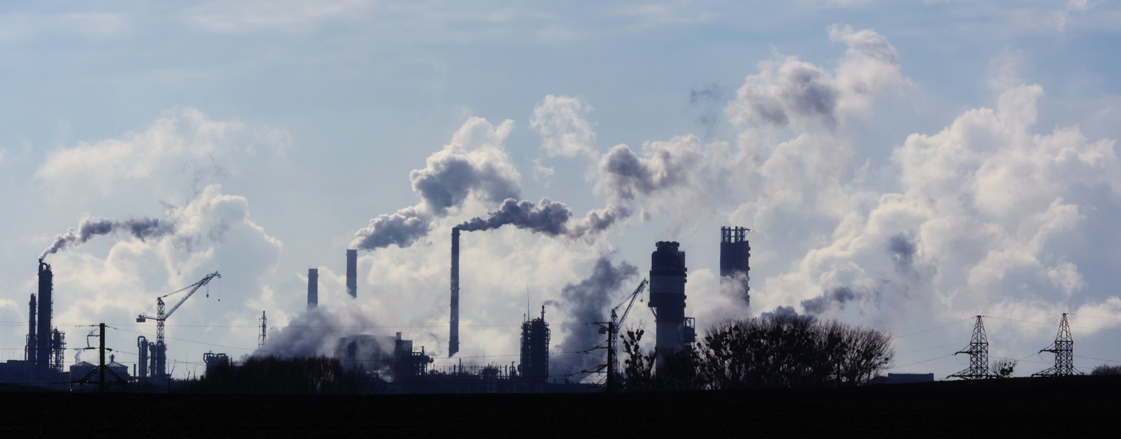 Air pollution from smoke coming out of factory chimneys.