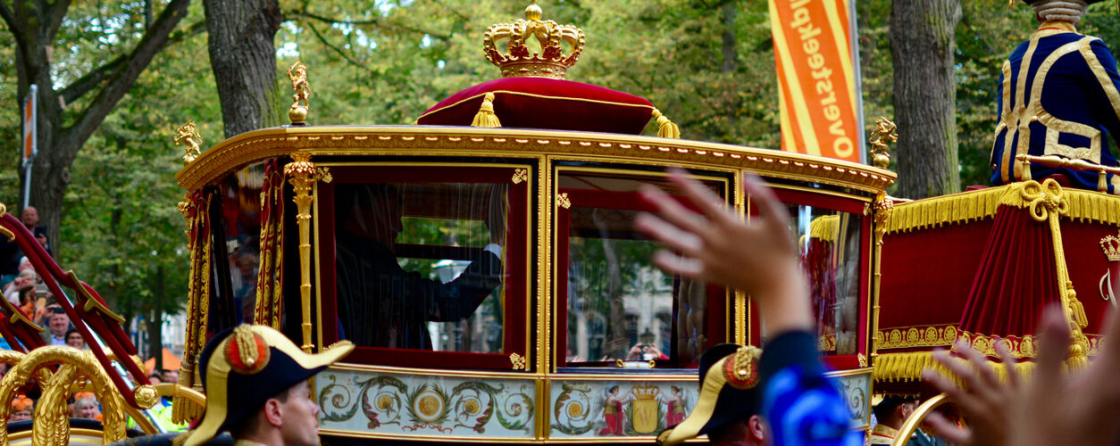 The Hague, Netherlands - September 20, 2016: King Willem-Alexander and Queen Máxima waving to the public on Prince's Day, from the glazed koets, the glass carriage