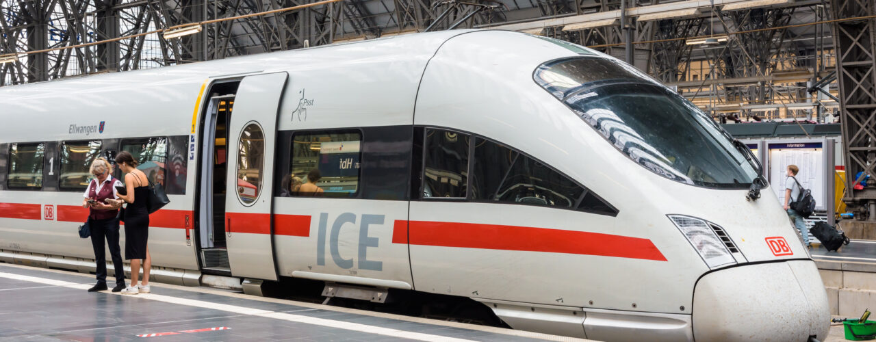 Frankfurt am Main, Germany - Aug. 19, 2023: An inspector checks the e-ticket of a young woman in front of an ICE high speed train from the Deutsche Bahn railway company in Frankfurt Central Station.