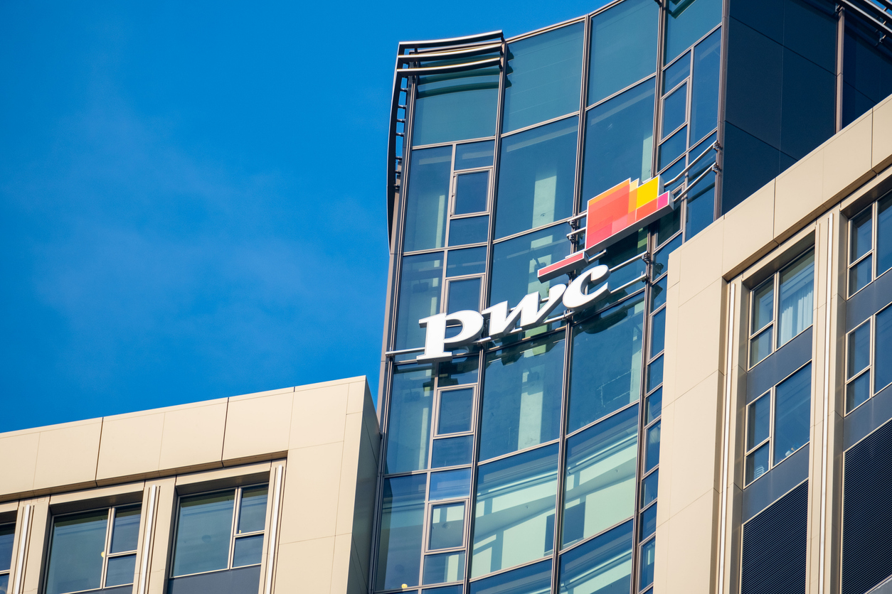 PwC logo on glass facade, high-rise glass office building against blue sky, finance and consulting, global economy, professional financial services in Germany, Frankfurt - February 9, 2025