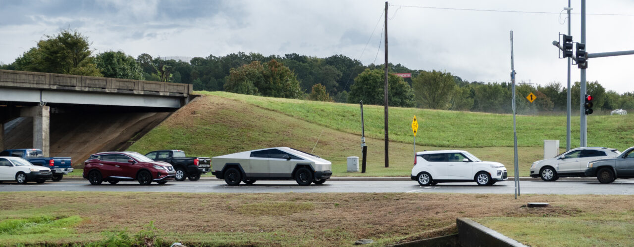 September 22, 2025, Van Buren, Arkansas. A Tesla Cyber Truck in traffic near a bridge overpass and an intersection with traffic lights.