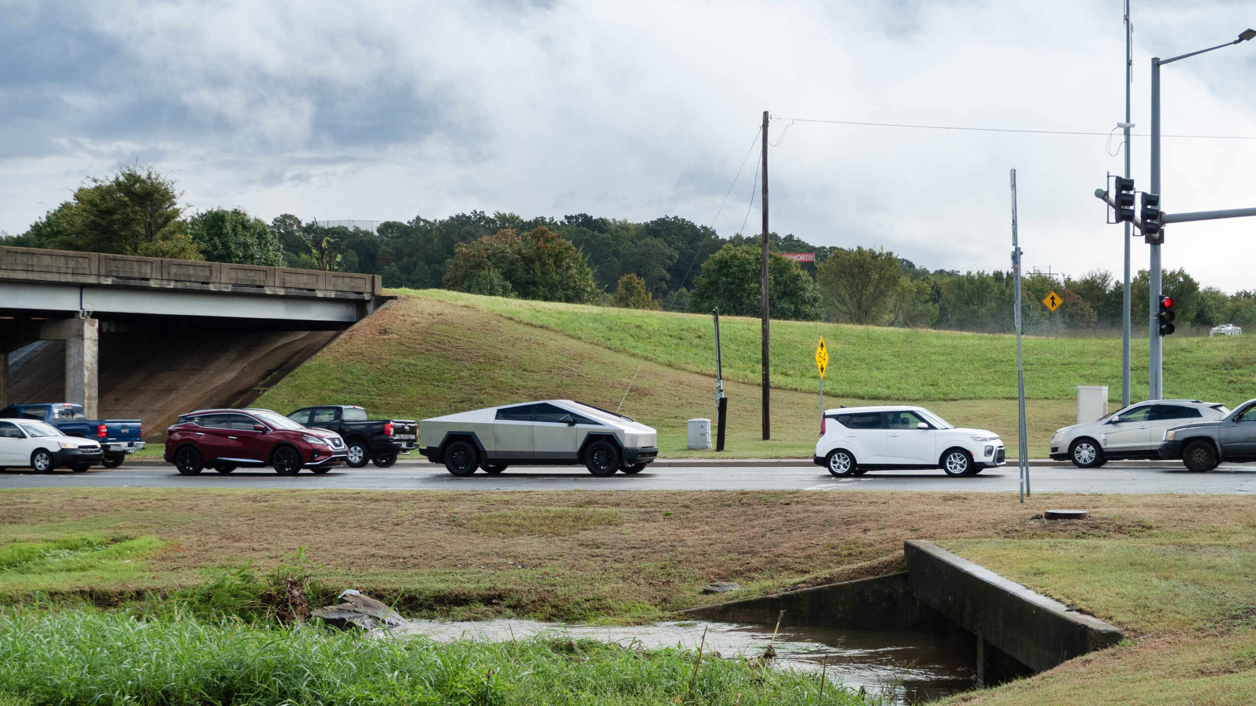 September 22, 2025, Van Buren, Arkansas. A Tesla Cyber Truck in traffic near a bridge overpass and an intersection with traffic lights.