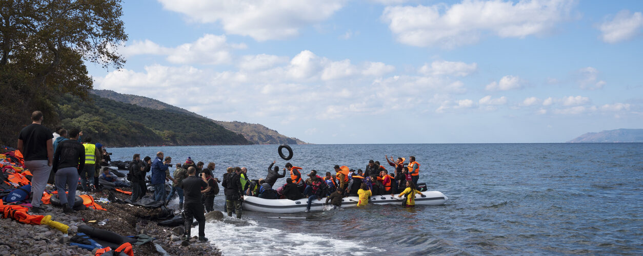 Skala Sikamineas, Lesbos, Greece - October 25, 2015: An inflatable boat filled with refugees and other migrants arrives on the north coast of the Greek island of Lesbos, where it is met by volunteers and photographers. More than 500,000 migrants have crossed from Turkey to the Greek islands so far in 2015.