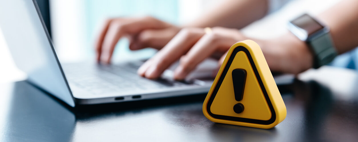 Warning sign placed on a table while businesswoman work.