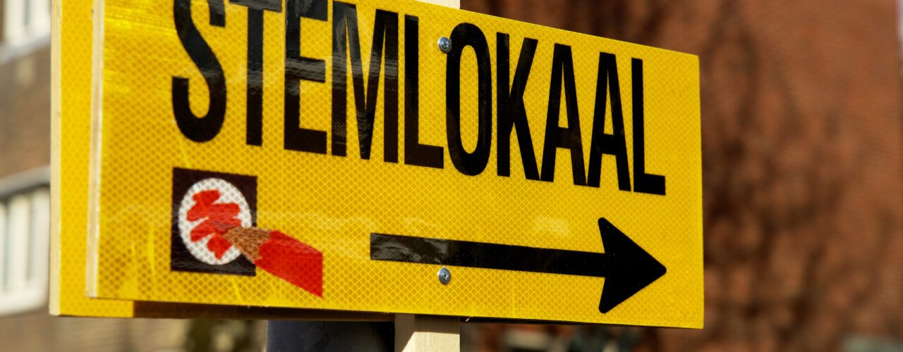 Close up of a sign pointing to the voting booth for dutch city council elections stemlokaal stemmen