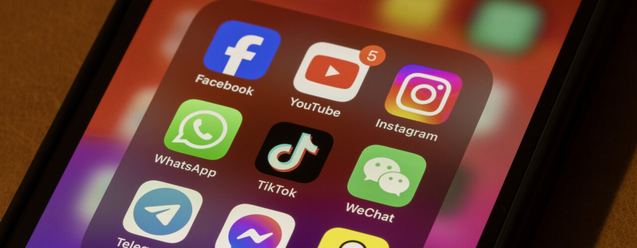Portland, OR, USA - Nov 11, 2024: Some of the most popular social media apps by number of monthly active users, including Facebook, YouTube, Instagram, WhatsApp, TikTok, WeChat, Telegram, Messenger, and Snapchat, are seen on an iPhone.